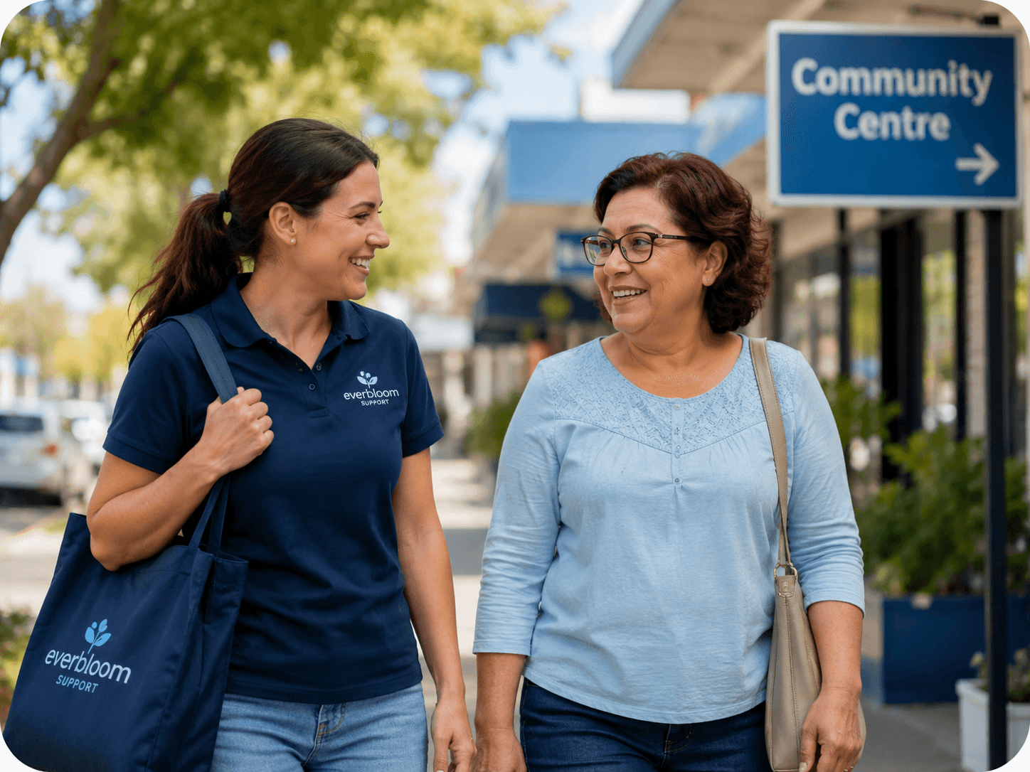 A support worker and participant walking together near a community centre
