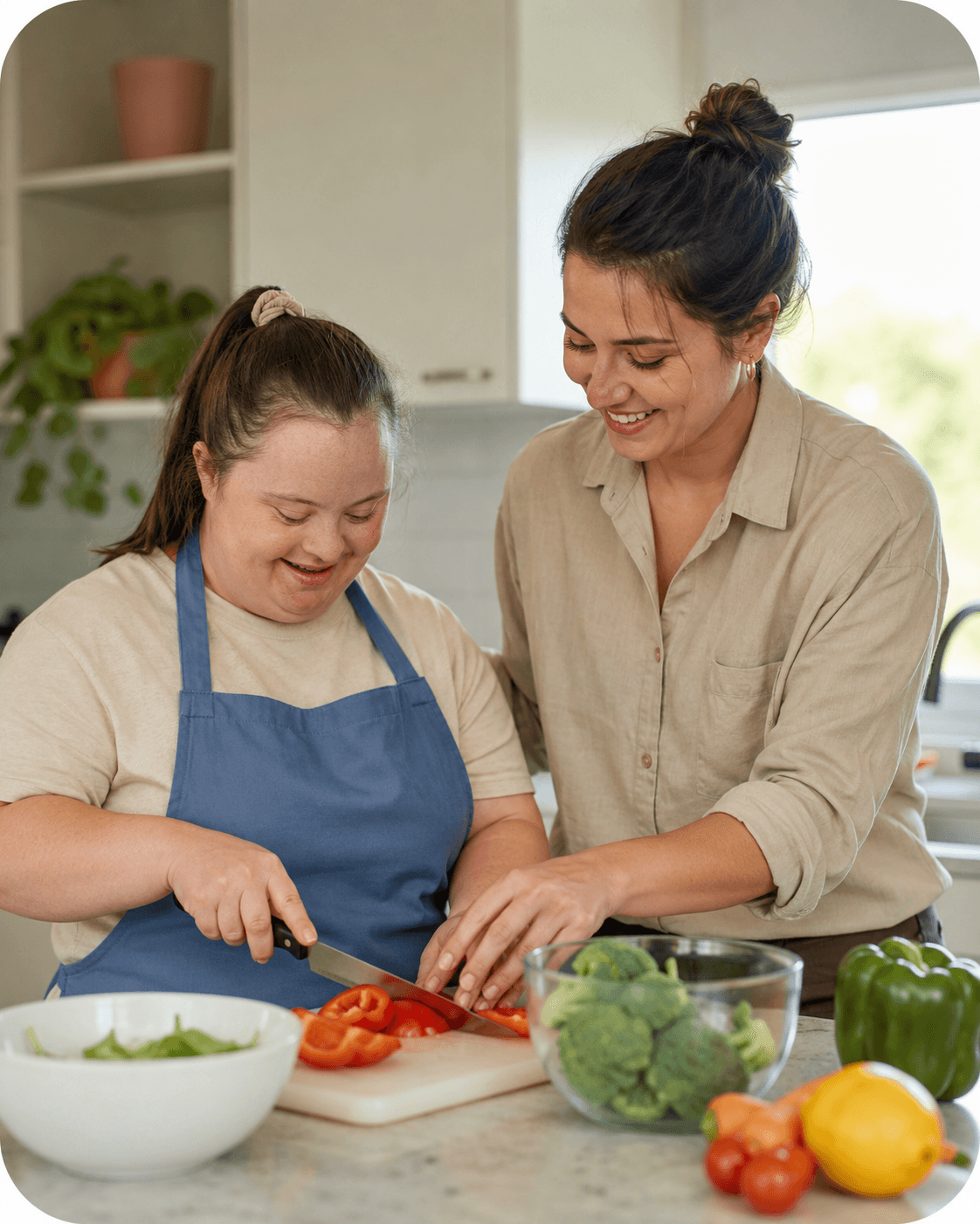 A support worker helping a participant chop vegetables in the kitchen